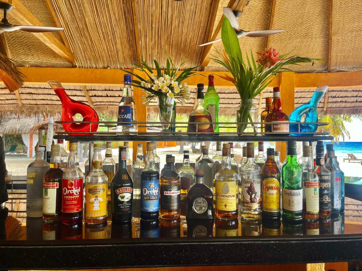 Coco Grove Beach Resort, Siquijor Island Exterior foto Rum bottles at a bar in the Caribbean
